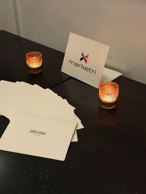 Candles and a Marketri card on a table set for the team during the annual retreat