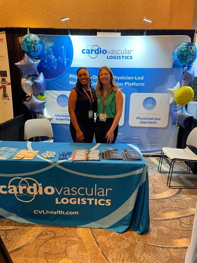 Photo Crystal and Katie in front of the CVL booth at NCVH