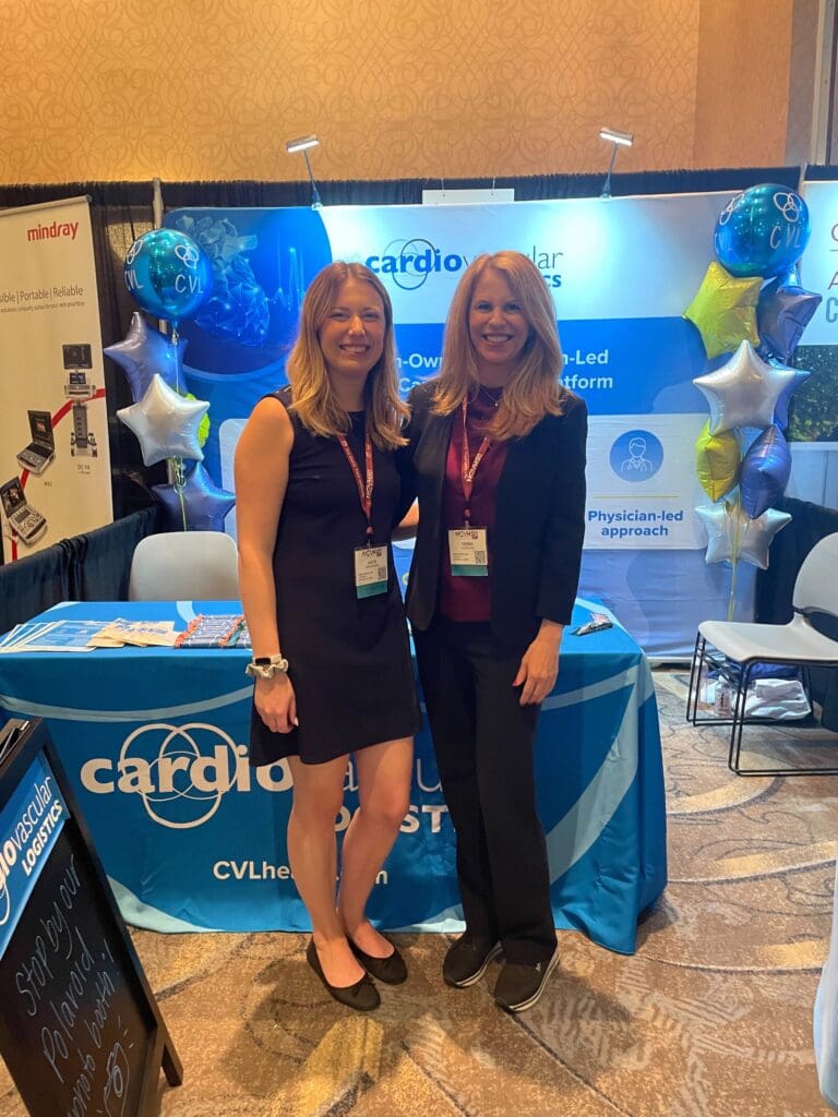 Katie and Deb posing in front of the CVL booth at NCVH